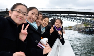 The slight chill didn't stop us from enjoying the magnificence that is Paris. Dancers (L-R) Ming Na, Ashley Wei, Cherie Zhou, Angela Xiao, and Alison Chen pose for a photo on the River Seine. (Annie Li)