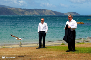 From right: Conductor Milen Nachev, violist Derek Hensler, and a New Zealand seagull brave the strong winds sweeping through Fitzroy Bay. (photo by dancer Ben Chen)