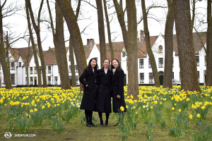 Dancers Yi-Qian Shi, Chunqiao Cai, and Connie Kuang enjoy the fresh field of flowers in the old town of Bruges. (photo by dancer Diana Teng)