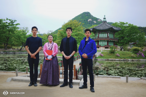 Dancers (from left) Patrick Trang, Jason Pan, and Joe Huang with a woman dressed in traditional Korean garb at the Hyangwonjeong Pavilion, meaning “The Pavilion of Far-Reaching Fragrance.” (photo by dancer Jun Liang)