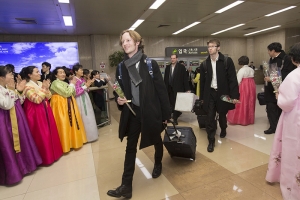 Shen Yun sound engineer Jacob Wallenberg (left) followed by trombone player Alistair Crawford and bassist Juraj Kukan upon arrival in South Korea.