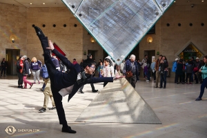 After waiting in the long line for tickets, dancer Zack Chan decided to feel the power of the Louvre pyramid. (Photo by dancer Jun Liang)