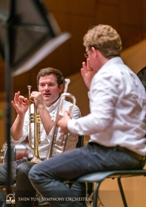 Trumpeters Eric Robins (left) and Jimmy Geiger deliberate the fine details of a trumpet part. (Photo by TK Kuo)