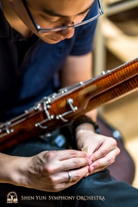 Bassoonist Steven Louie prepares reeds before the show.
