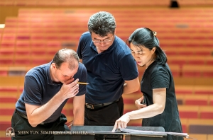 Double bassists Juraj Kukan, Wei Liu, and Hui-Ching Chen go over the score in Pingtung, Taiwan.