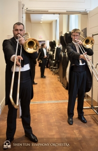 Behind the stage at Carnegie, principal trombonist Alexander Moraru (L) and trombonist Alistair Crawford warm up together with long tones.