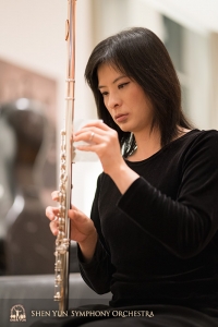 Principal flutist Chia-Jung Lee prepares her flute for the concert.