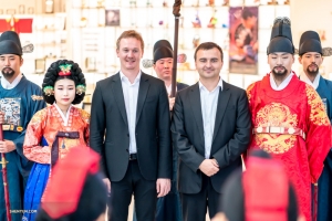 Principal Bassoon Aleksander Velichko (L) and bass trombonist Pavlo Baishev pose with Koreans wearing the traditional attire of the monarchs.