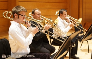 The trombone section practicing together before rehearsal. L-R: Alistair Crawford (principal), Ivan Agarkov, and Pavlo Baishev (bass trombonist).