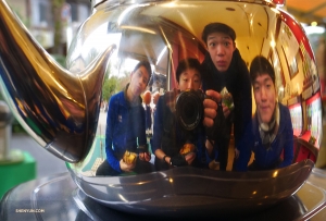 Crowding around a kettle of hot tea while eating cream puffs. Left to right: dancers Shawn Ren, Ben Chen, Teo Yin, and Leo Lee.