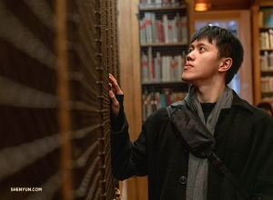 Monty Mou scans the shelves stocked with dance and opera books at the library-museum of the Palais Garnier. (Photo by Andrew Fung)