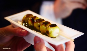 On the other side of the world, our dancers bite into Japanese&nbsp;aburi-mochi, grilled rice cakes on bamboo skewers&mdash;a thousand-year-old Kyoto confection.