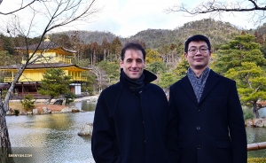 Emcee Leeshai Lemish (left) and stage manager Gregory Xu with the ancient Buddhist temple.