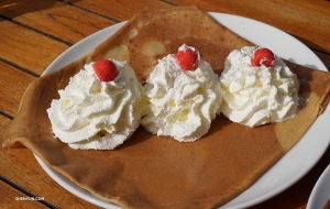 Sampling the local crepes is a must. There seems to be more whipped cream than crepe, but that&rsquo;s not a problem. (Photo by Kexin Li)