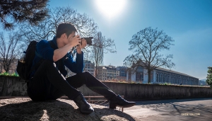 With the theater in the background, a dancer/photographer pauses to focus for the perfect shot. (Photo by Monty Mou)