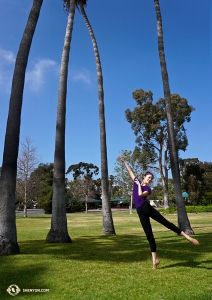 Principal Dancer Daoyong Zheng dances amongst the towering trees near the harbor. (Photo by dancer Kexin Li)

