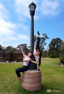 A lamp post comes in handy for dancers Daoyong Zheng (left) and Angela Xiao.
