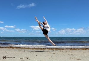 Dancer Wendy Ba on the sandy shoreline at Dania Beach in Fort Lauderdale.
