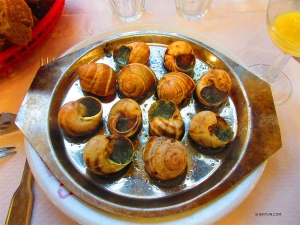 The brave sample the famous French dish escargot (aka snails).