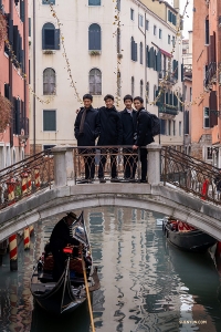 Dancers stop on one of the over 400 bridges that link Venice together as a gondola passes underneath.

(Photo by William Li)