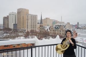 Meanwhile, on a record-breaking-snowfall weekend, french horn player Chi-Chien Weng warms up while cooling down in snowy Detroit, Michigan.

(Photo by Grace Mo)
