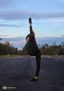 Dancer Jiajia Li steps off the bus and takes the opportunity to do some stretching in the parking lot (she didn't even warm up before doing this!).

(Photo by Kaidi Wu)