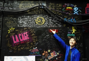 Back stage, a dancer is delighted to find autographs from the company in previous years.