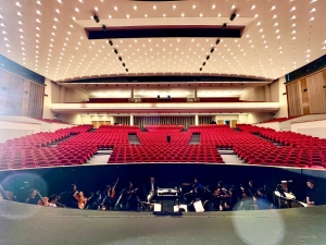 A view of the auditorium at Kursaal Oostende in Belgium. The musicians in the orchestra pit are hard at work perfecting their craft, ready to delight the audience.