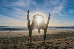 Even the sun seems to join in the fun, peering through a heart made by the skillful limbs of Shen Yun's dancers, shining on both their flexibility and their high spirits!